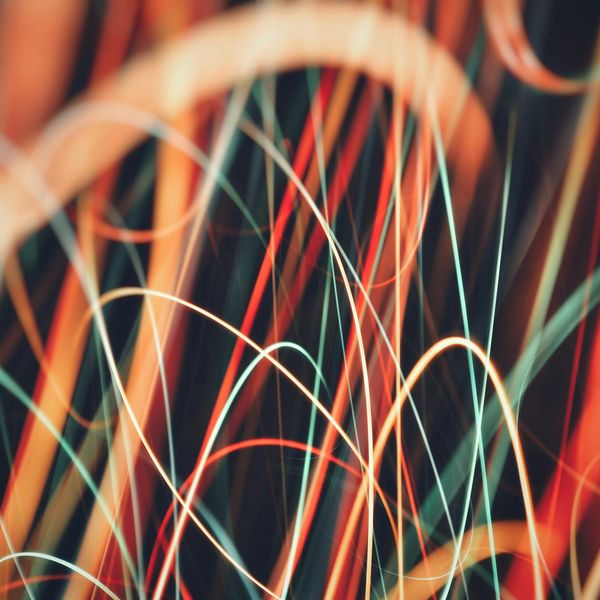 Abstract representation of energy flow with graceful lines on a dark background.